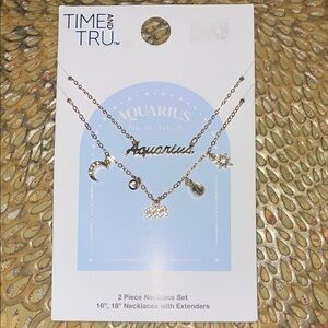 Set of 2 Adjustable Aquarius yellow gold tone necklaces with extenders & charms.